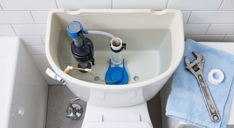 DIY homeowner inspecting internal parts to fix a running toilet